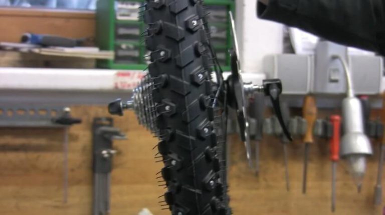 Spike-Reifen für sicheres Radfahren im Winter, in einer Werkstatt montiert.
