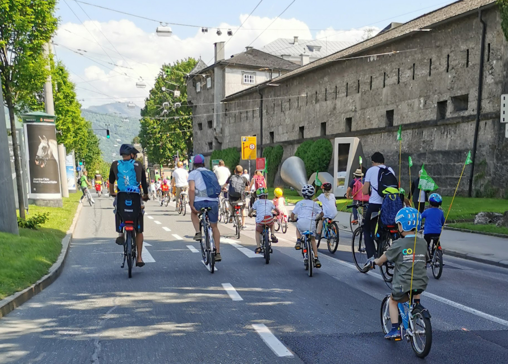 Erwachsene und Kinder fahren auf Straße im Rahmen von Cridical Mass